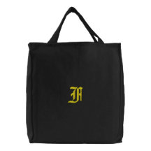 Den broderade monogramen för brev E hänger lös Tygkasse