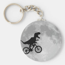 Dinosaur på en cykel i himmel med månen nyckelring