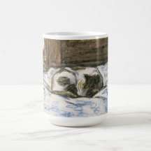 Katt som sovar på en säng vid Claude Monet Kaffe Kopp