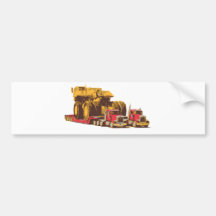 Two Semi Big Trucks carrying a Huge Mining Truck Bumper Stickers
