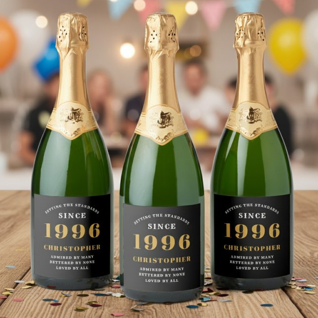 30-årsdag Född 1996 Lägg till namn Svart Guld (Born 1996 birthday sparkling wine labels. Background out of focus.)