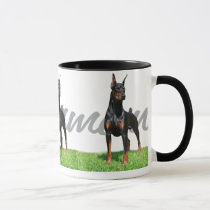 3 svart DobermanPinschers med det grafiska Mugg