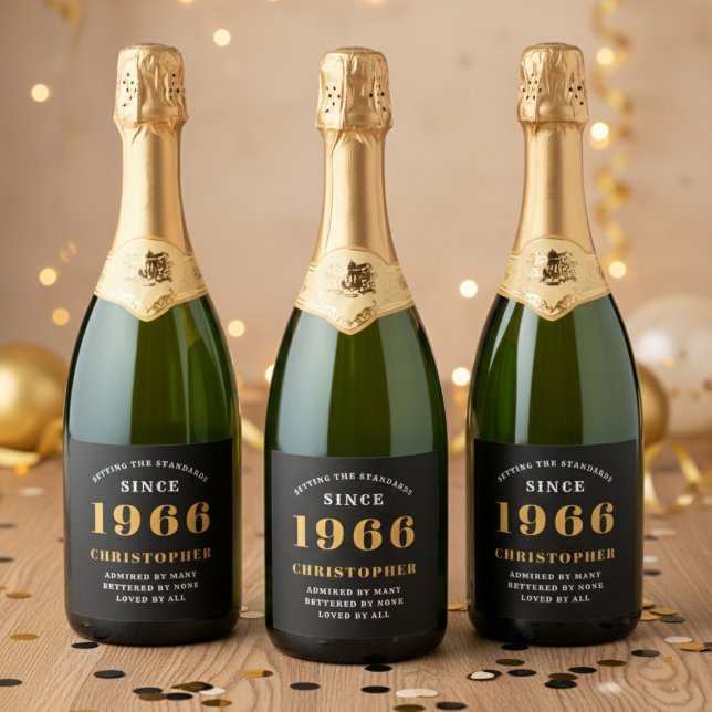 60-årsdag Född 1966 Lägg till namn Svart Guld (Born 1966 sparkling wine label. Background out of focus.)