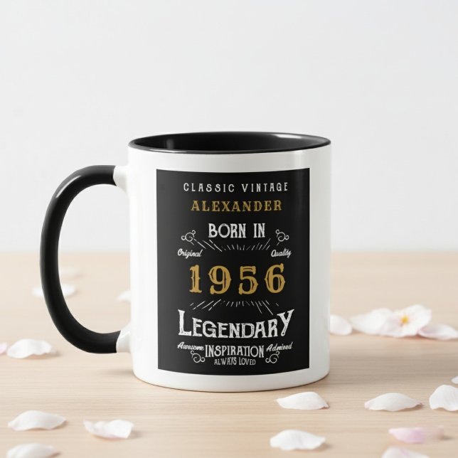 70th Birthday 1956 Legend Retro Black Personalized Mugg (Born 1956 birthday gift mug. White wall background, wood table with petals.)