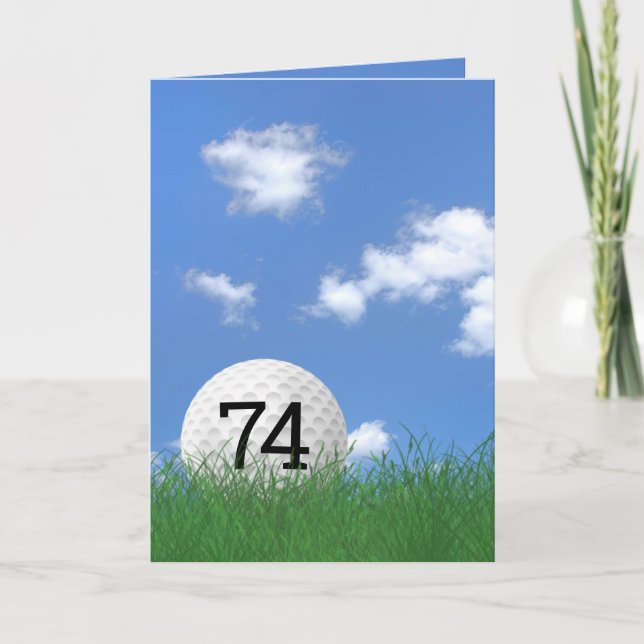 74-årsdag, golfboll i gräs kort (Framsida)