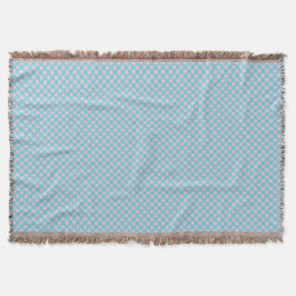 A light blue blanket with a subtle diamond pattern filt