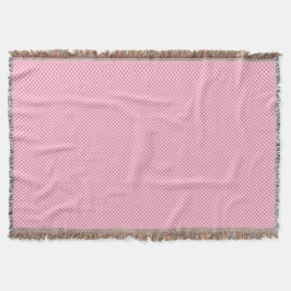 A pink woven blanket with a subtle pattern  filt