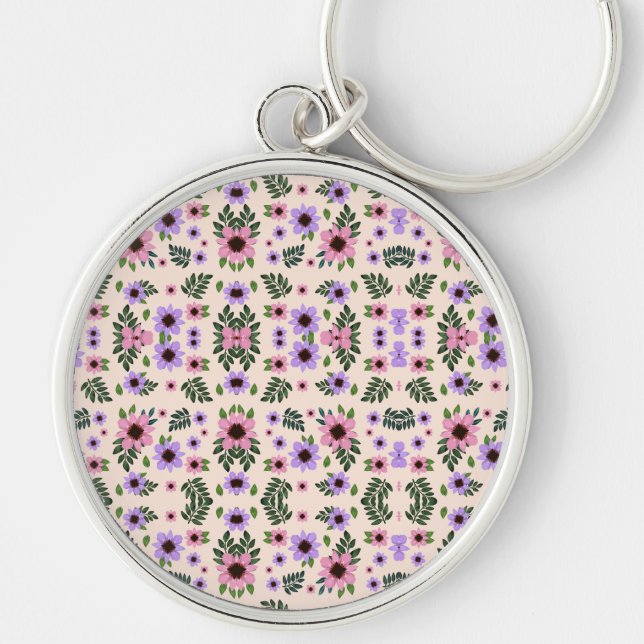 A round keychain featuring a vibrant floral  rund silverfärgad nyckelring (Framsidan)