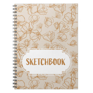 Abstrakt blommor över beige anteckningsbok