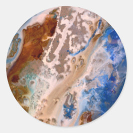 Abstrakt sandstrand mönster vatten skummet mönster runt klistermärke