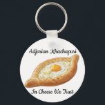 Adjarian Khachapuri  Nyckelring<br><div class="desc">Adjarian Khachapuri is a traditional Georgian dish from the region of Adjara, located along the Black Sea coast of Georgia. It is a boat-shaped bread made from soft yeast dough, filled with melted cheese, and topped with a fresh egg yolk and a slice of butter. Before eating, the egg and...</div>