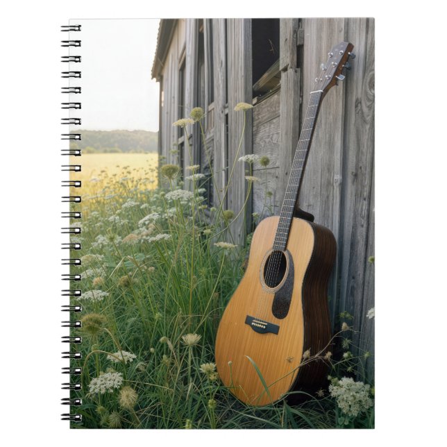 Akustisk gitarr lutande mot en lanthandel anteckningsbok (Framsidan)