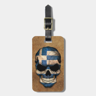 Åldrig och sliten grekisk flaggaskalle bagagebricka
