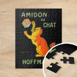 Amidon Au Chatta | Leonetto Cappiello Pussel<br><div class="desc">Amidon Au Chatta (1903) | Leonetto Cappiellos vintage poster Amidon Au-Chattan för Hoffman har en katt av vismisk orange som på ett lekfullt sätt samverkar med en stärkelsematch, som ställs mot en slående svart bakgrund. Kattens pulserande orange och den feta typografin skapar en högkontrastsdesign som både fångar öga och är...</div>