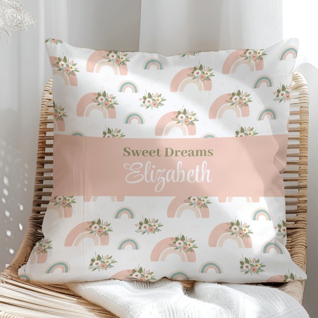Anpassad namnfyllning för rosa Blommigt Regnbåge Kudde (Pink Floral Rainbow Custom Name Pillow on a sunny rattan armchair.)