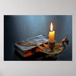 Antik bok och ett brinnande ljus poster