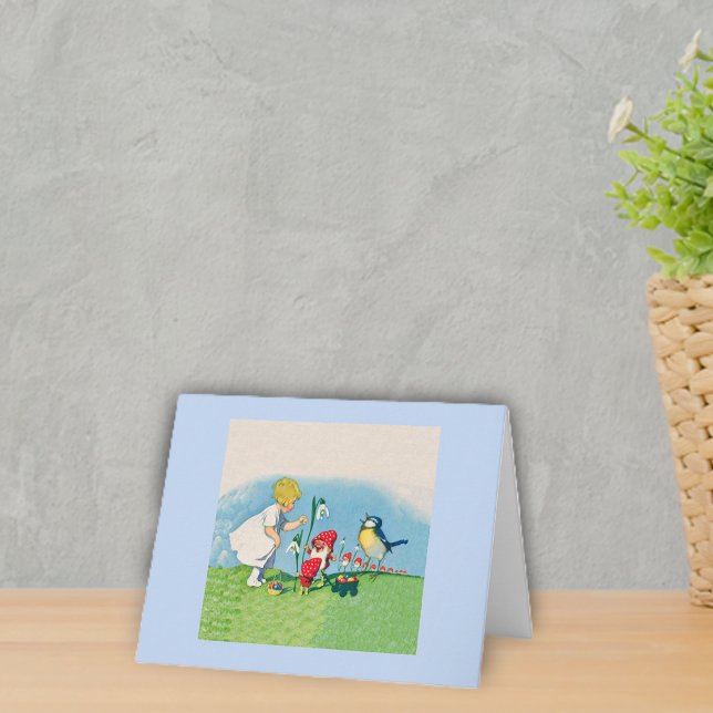 Antika älvor fågel påskägg helgkort (Little girl with singing bird and cute elves in red hats in grass with flowers light blue notecards.)