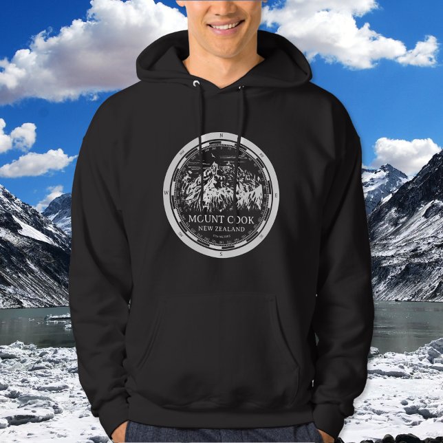 Aoraki Mount Cook - Canterbury Nya Zeeland Hoodie (Mount Cook New Zealand Hoodie in Back with a white compass and mountain illustration)