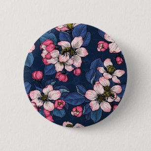 Äppelblommar på en mörk blått knapp