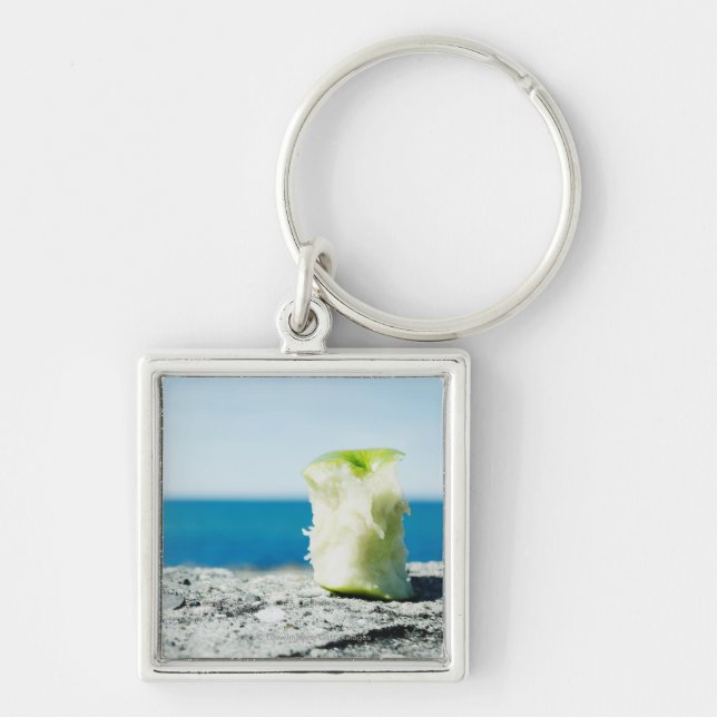 Apple kärnar ur i smutsen fyrkantig silverfärgad nyckelring (Framsidan)