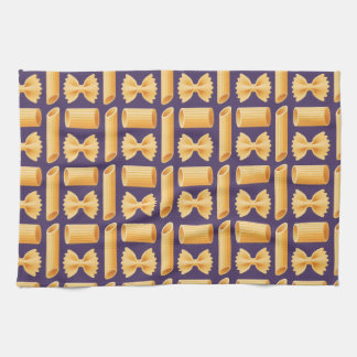 Array of various pasta shapes on a purple kökshandduk