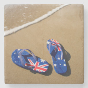 Australiensisk flaggabadskor på strand   södra stenunderlägg