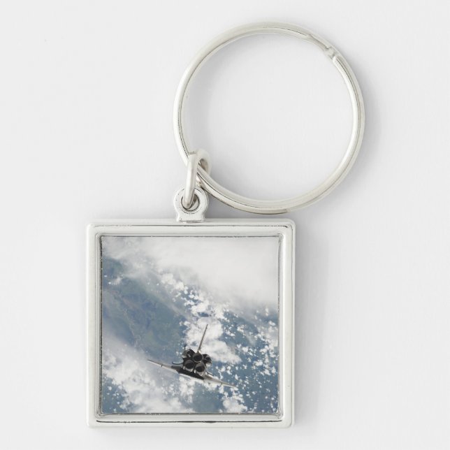 Bakre vy av de tre huvudmotorerna fyrkantig silverfärgad nyckelring (Framsidan)