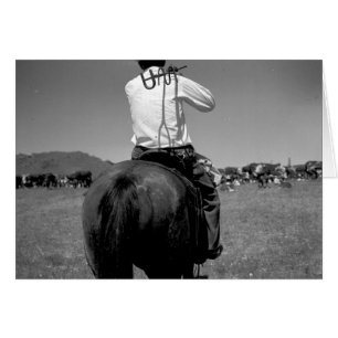 Baksidaen beskådar av en cowboy på en häst med hälsningskort