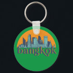 Bangkok Thailand Retro City Skyline Cityscape Art Nyckelring<br><div class="desc">Vintage- och reflexritorier med vackra skyliner, attraktion och cityscape-konst. Coola skyscraper och byggnad silhuette illustrerar handelsvara för turister och resenärer. Perfekt som souvenir att ta med sig hem när man reser värld runt. Spara minnet av din resa och semester med familj och vänner. Bakgrunden till färg kan anpassas till färg....</div>