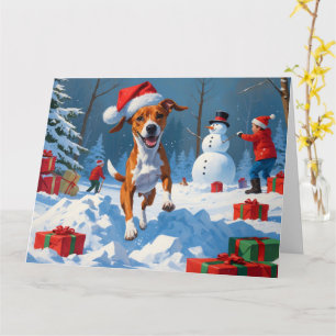 Basenji-hund som leker i snö Vinterscen Kort