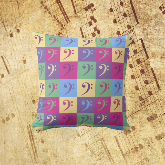 Bass Clef Music Mönster Bright Kudde (A throw pillow with a colorful pattern of bass clef symbols.)