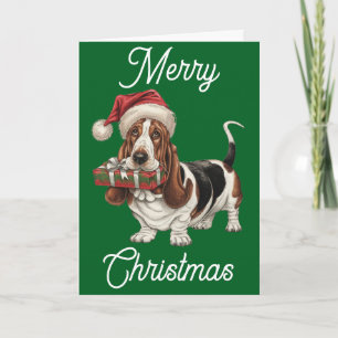 Basset Hound i julhatt present i munnen Kort