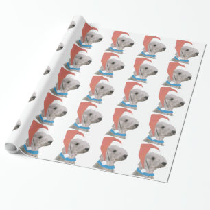 Bedlington Terrier i den Santa hatten som slår in Presentpapper