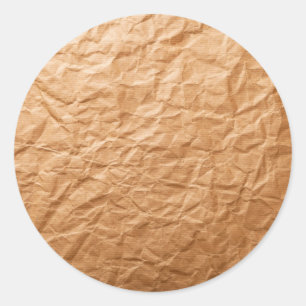 Beige skrynkligt papper runt klistermärke