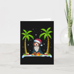 Bernedoodle Hund Santa Hat Handflatan Träd Beach J Kort