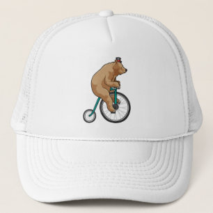 Björn i cirkus med cykel keps
