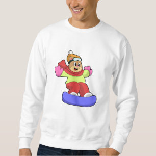 Björn vid snowboardingbombord med snötbord lång ärmad tröja