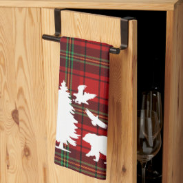 Björnhäst vid gräs träd vid rödsvarta tartan kökshandduk