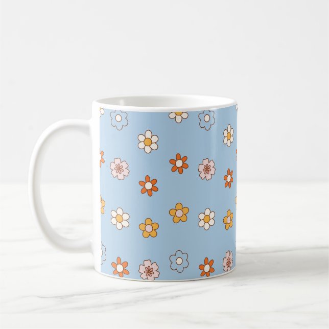 Blå bakgrund med blommor i olika färger kaffemugg (Vänster)