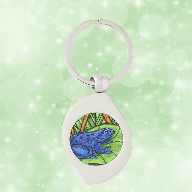 Blå giftvibrant groda swirl silverfärgad nyckelring (Blue poison Frog on green lily pad with yellow reeds grass on keychain.)