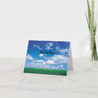 Blå himmel med fluffiga moln och grönt gräs kort
