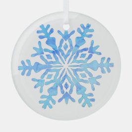 Blå snöflingor på en glasprydnad julgransdekoration