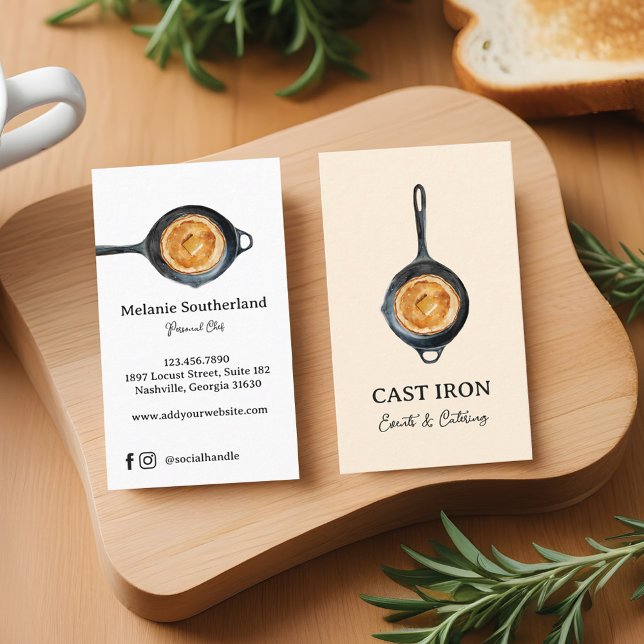 Black Cast Järn Skillet Personal Chef & Catering Visitkort (closeup of two blank white vertical business card resting on a wooden butcher block countertop along)