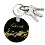 Black guld musik noter monogram namn nyckelring<br><div class="desc">Enkel och elegant för en musik i älskare! Svart bakgrund med faux guld musik noter. Mall för ditt namn,  skript för stil med gyllene bokstäver.</div>