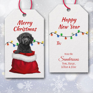 Black Labradoodle-Hund i Santa Bag Gift-Märkre Presentetikett
