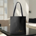 Black Namn Guld Girly Script Monogram Modern Tygkasse<br><div class="desc">Svart och Guld Elegant lägg till din egen Namn Monogram Bok Bag. Denna Bok-bag kan anpassas så att den omfattar ditt första och första namn och ges som julklapp,  Sverige 16 födelsedagar,  Möhippa eller Bröllop.</div>