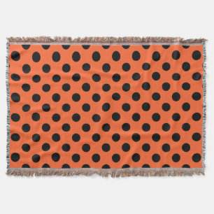 Black polka dots på orange filt