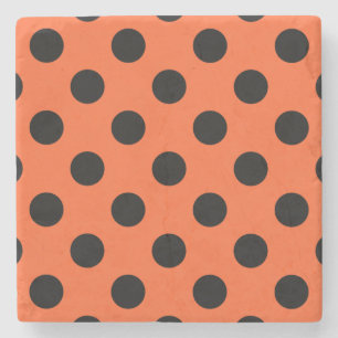 Black polka dots på orange stenunderlägg