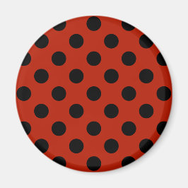 Black polka dots på röd magnet