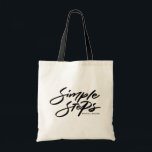 Black Simple Steps Quote Modern Calligraphy Tygkasse<br><div class="desc">The "Simple Steps" tote bag is the perfect combination of modern design and practicality. Crafted from durable canvas,  it’s great for carrying your essentials. You can personalize this black and white with your name or a meaningful phrase,  making it a unique and functional accessory for everyday use.</div>